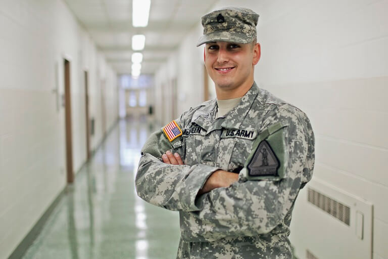 man in military uniform posing in hallway