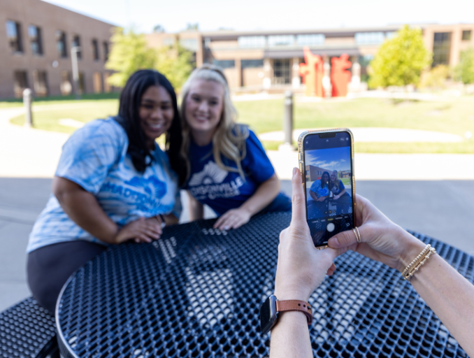 girl taking picture of other girls