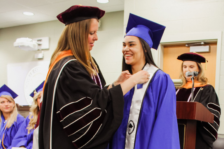 professor pinning nursing students