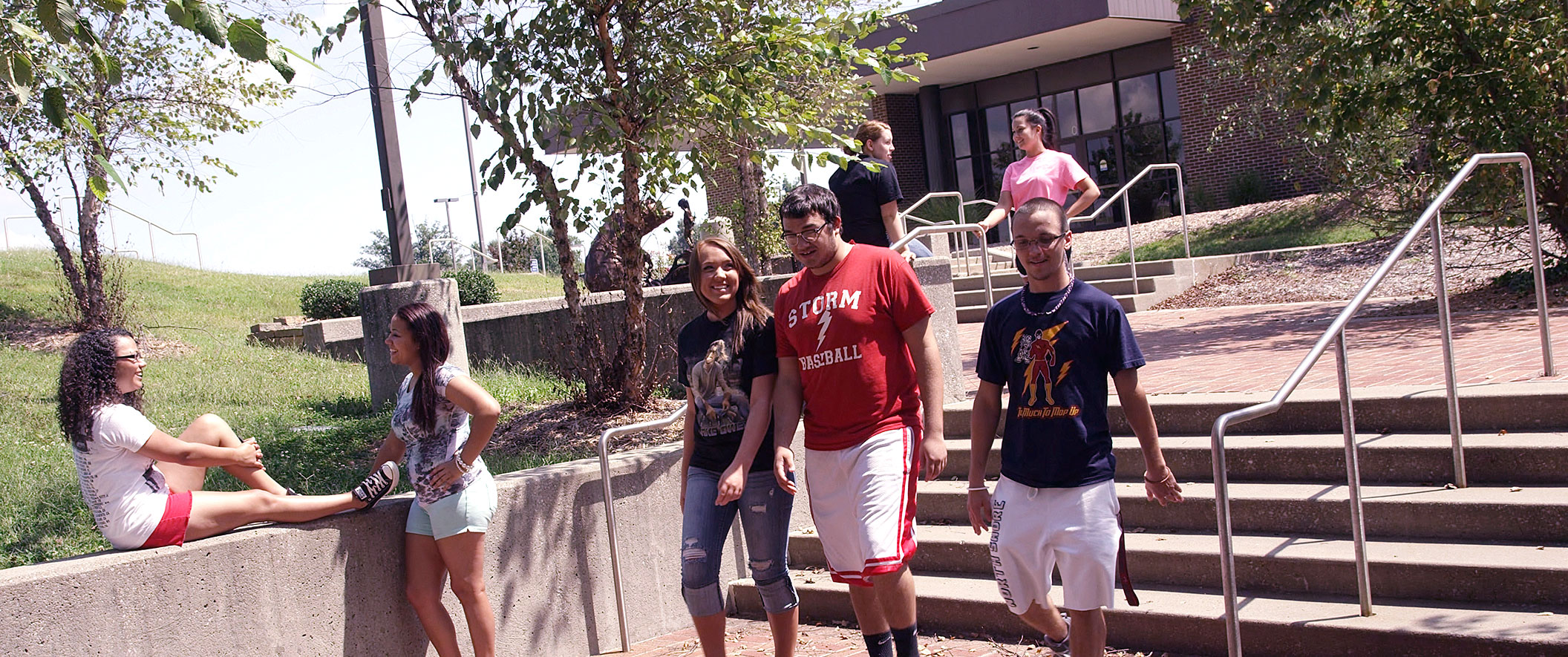 three students walking down stairs