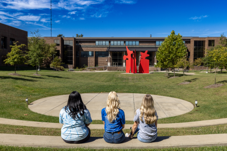 students sitting looking at courtyard