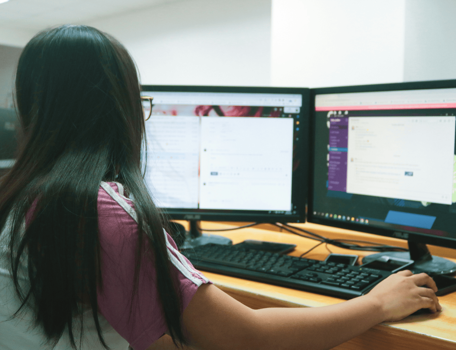 woman looking at computer screens