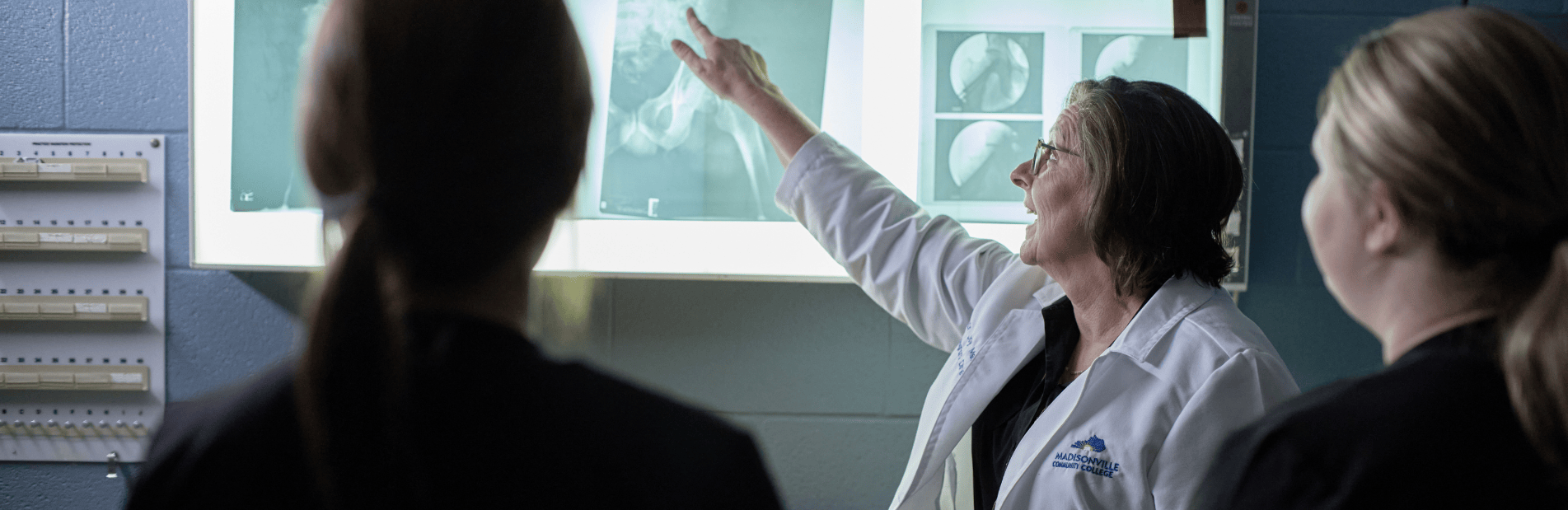 teacher pointing at xray scan
