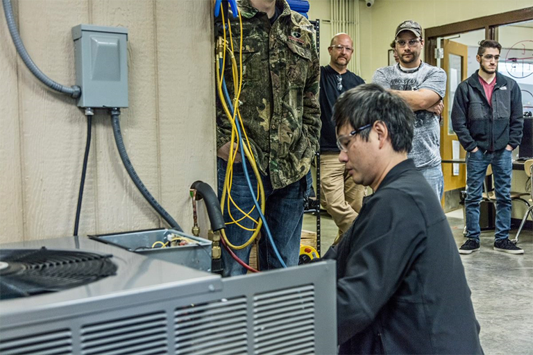 AC Student Working on AC Unit