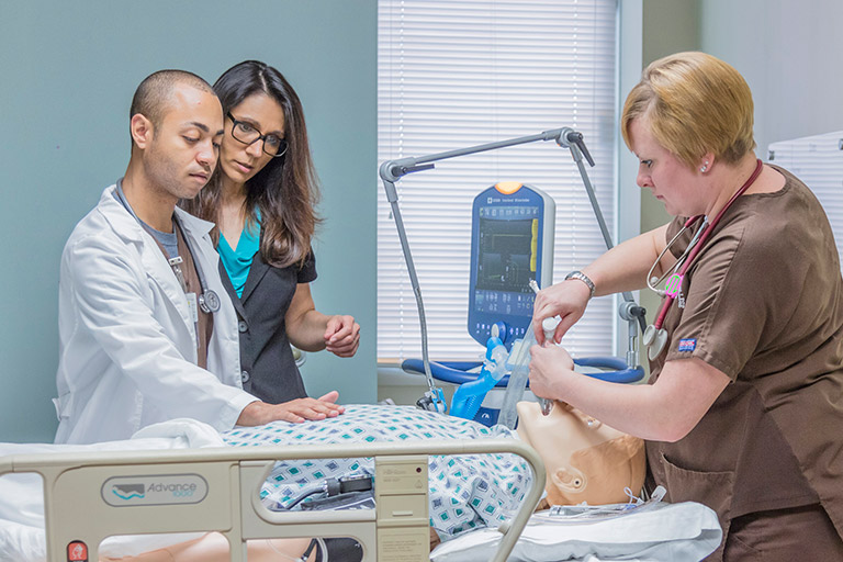 Respiratory Care Students and Instructors attending a patient