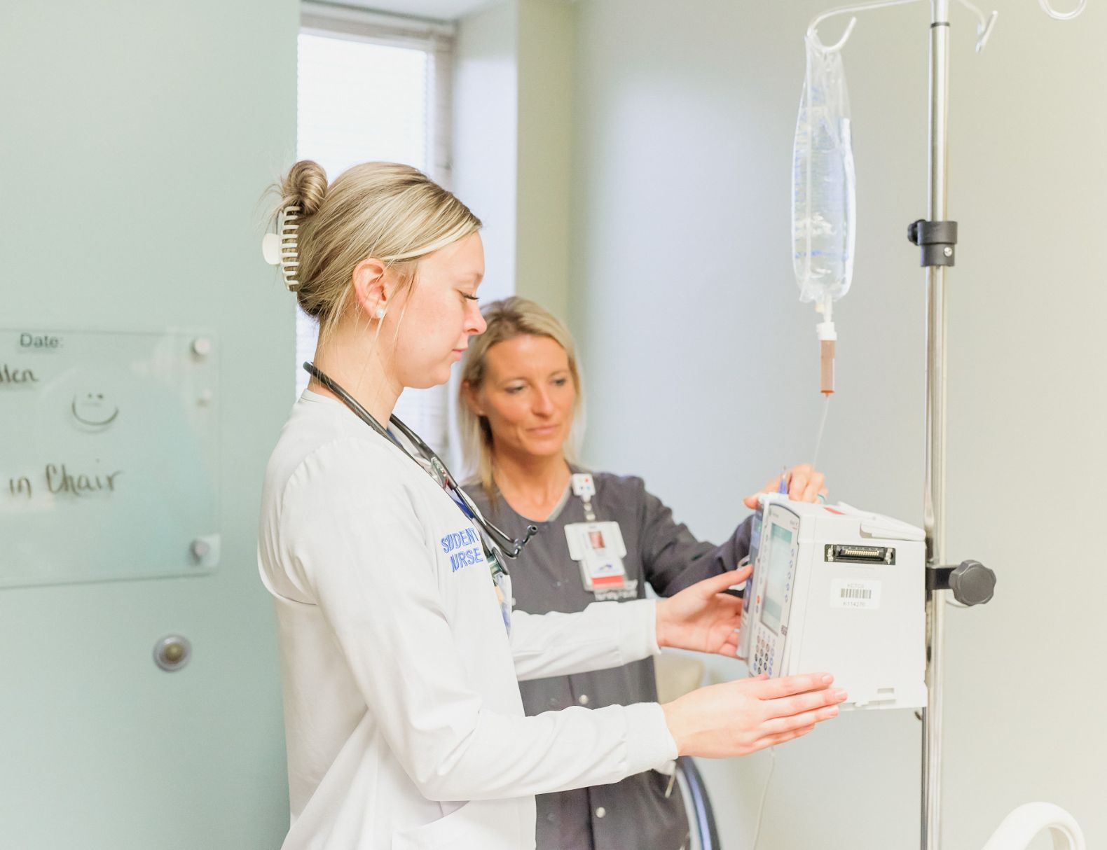 Nursing students learning about IV from instructor